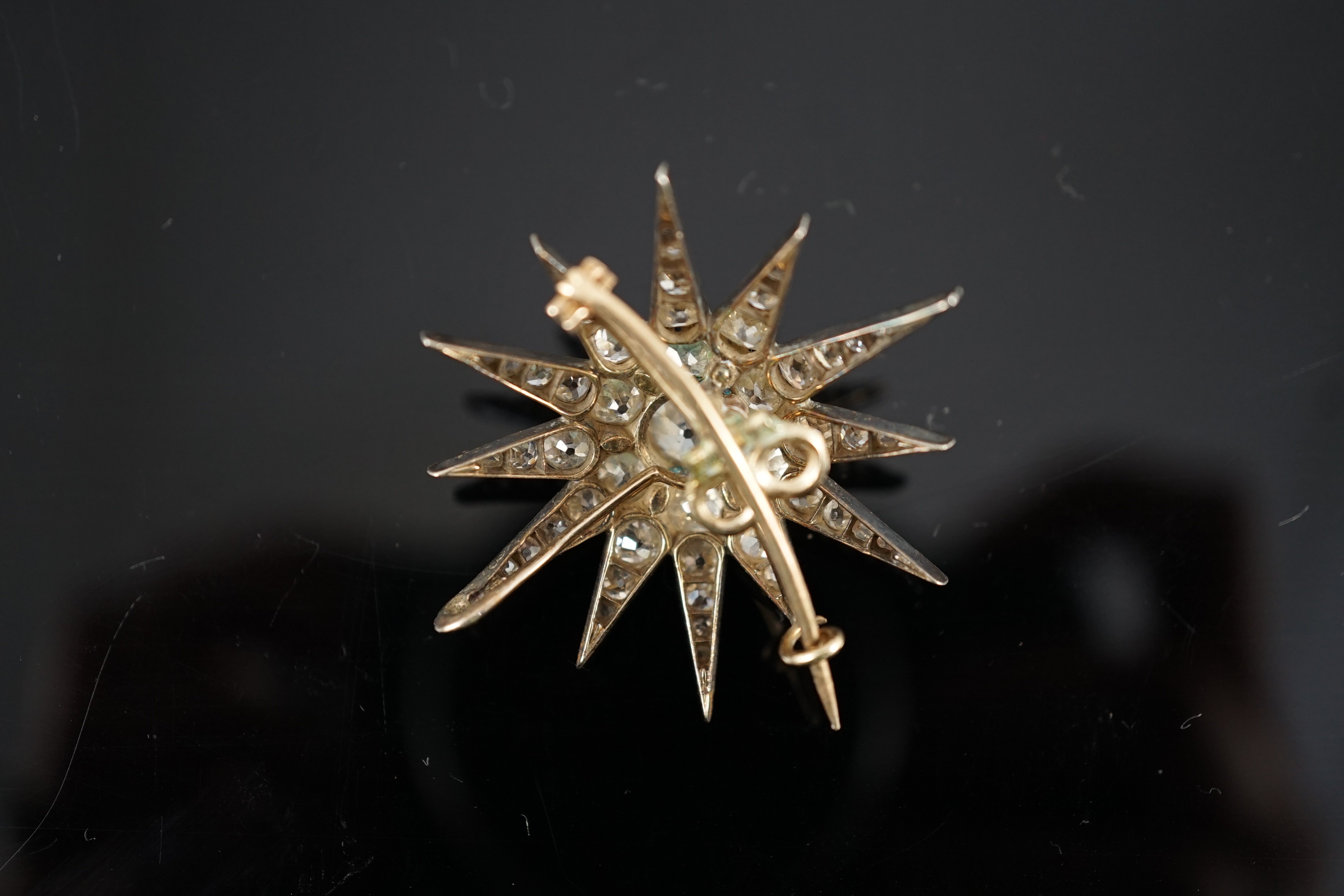 A Victorian gold, silver and graduated old cut diamond set starburst brooch